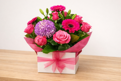 Jada'sCollection - A bold and vibrant collection of pink and purple flowers arranged beautifully in a gift box. Perfect for celebrating special moments or simply brightening someone's day.