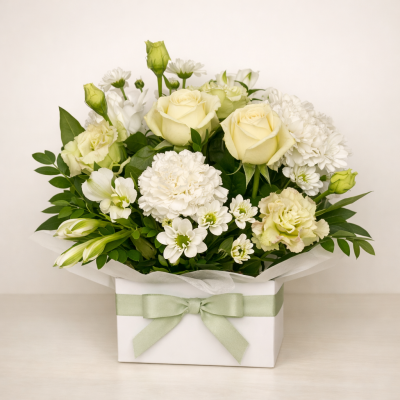 MEMORIES - A boxed arrangement is suitable for a sympathy tribute. Made with seasonal long-lasting blooms.