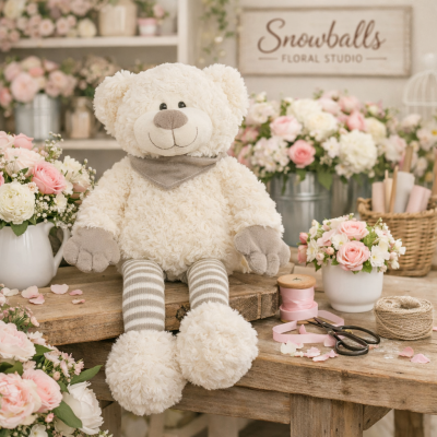 Sitting Teddy Bear - This bear has soft cream fur, striped legs, and a cozy scarf — this adorable plush bear brings warmth and charm to any floral gift. Perfect for birthdays, anniversaries, or just‑because moments.