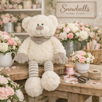 Sitting Teddy Bear - This bear has soft cream fur, striped legs, and a cozy scarf — this adorable plush bear brings warmth and charm to any floral gift. Perfect for birthdays, anniversaries, or just‑because moments.